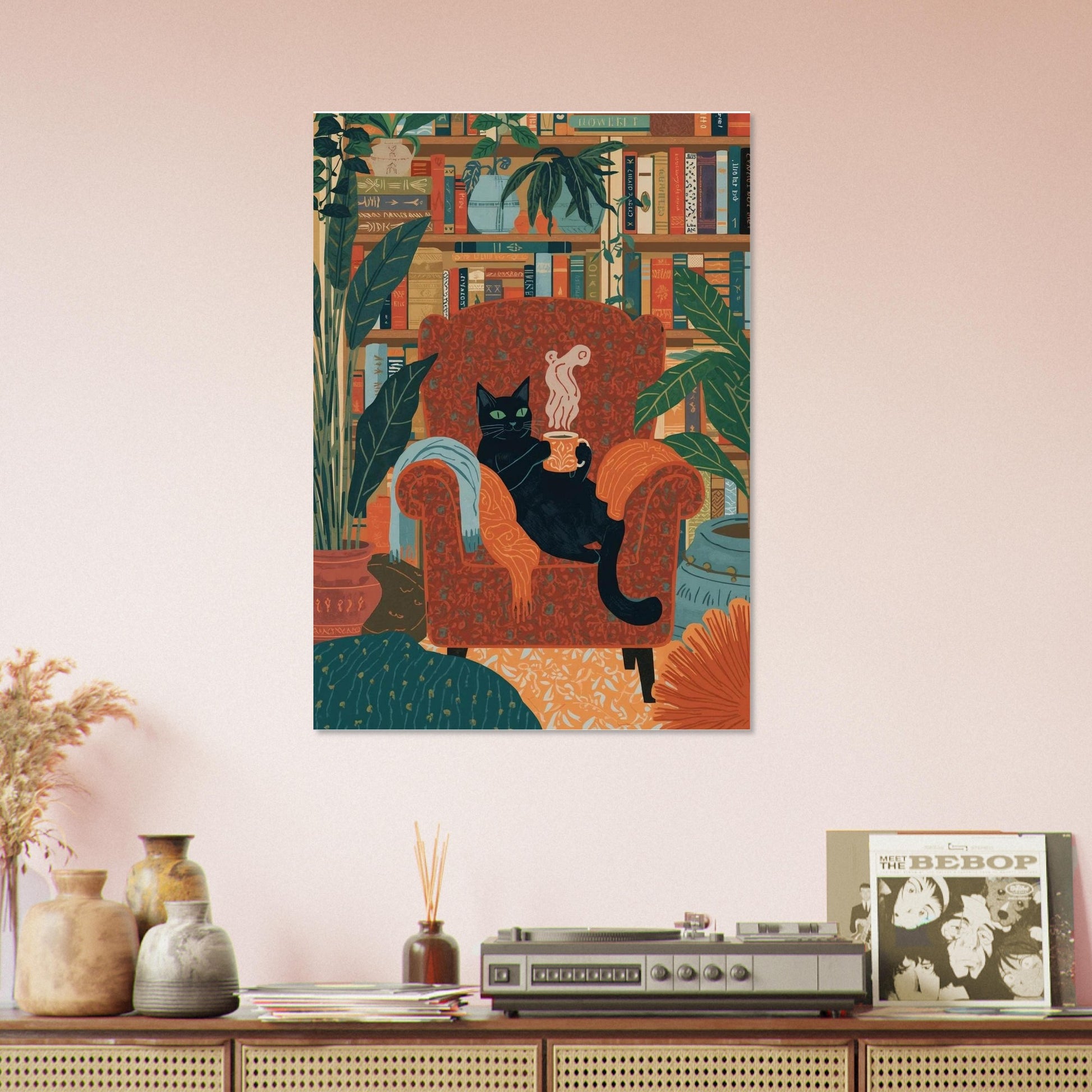Canvas print of a cat on an armchair with books and plants, above a wooden cabinet with decorative items.