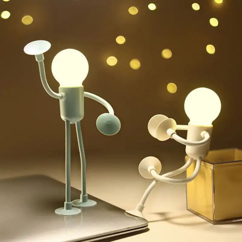 Two lamp-shaped figures with light bulb heads interacting against a warm, blurred background.