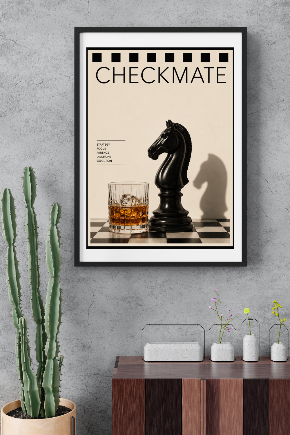 Framed poster with chess theme and drink on a wall above a wooden console table.