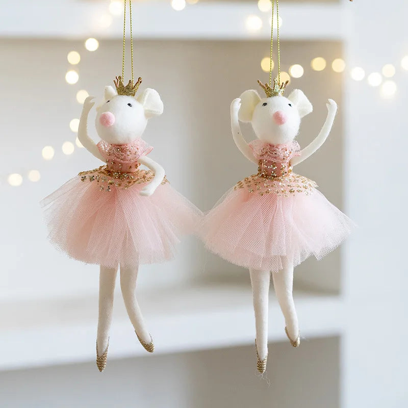 Two decorative mouse figurines in ballerina costumes hanging against a blurred light background.