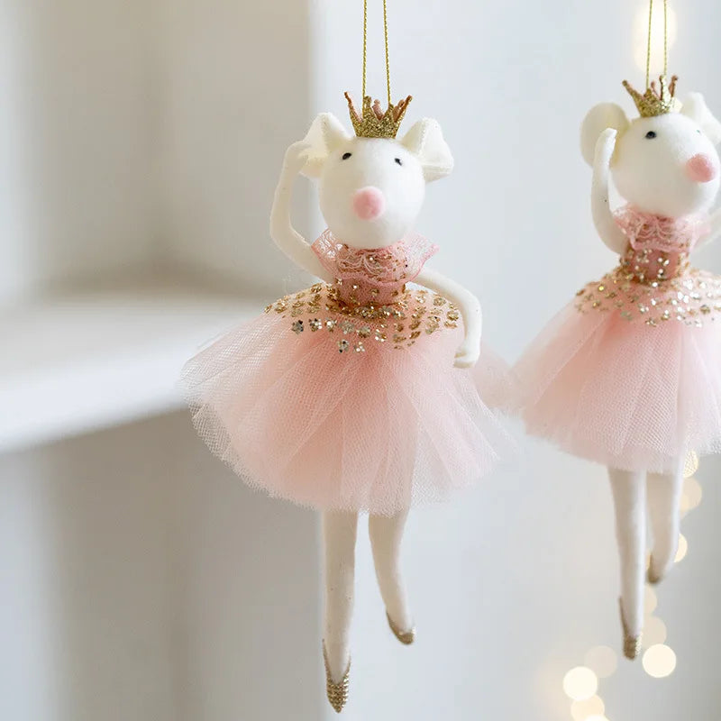 Two decorative mouse ornaments in pink tutus with gold crowns on a white background.