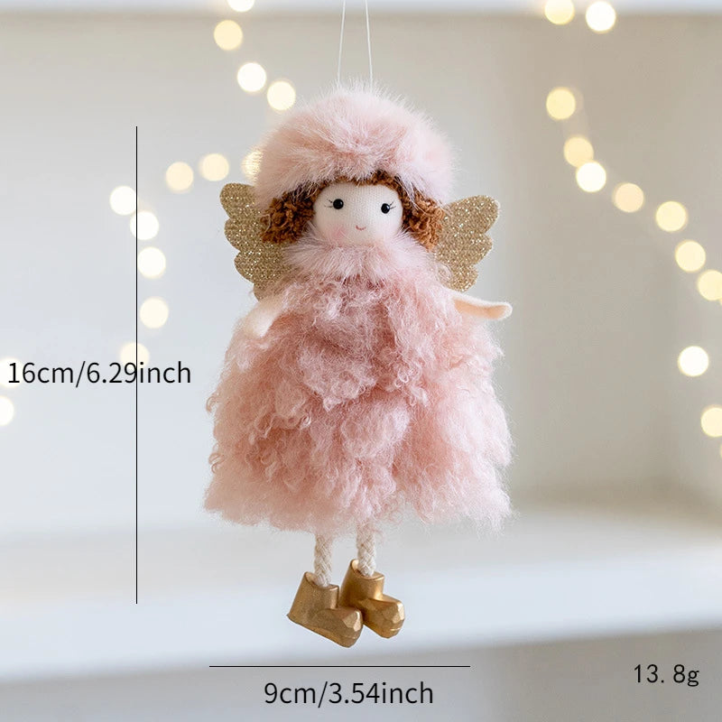 Pink fairy doll with gold wings and boots on a white background with string lights.