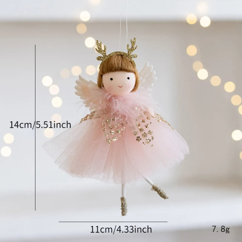 Small fairy doll with a pink dress and gold accents, hanging against a soft bokeh background.
