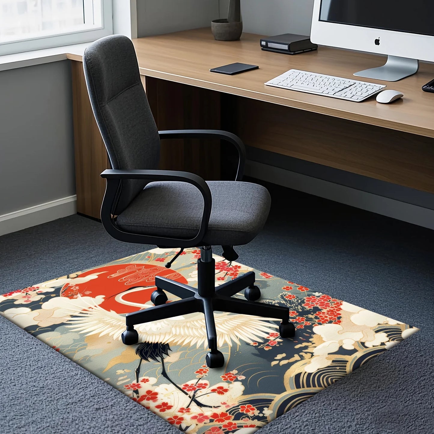 Decorative rug with a crane design in front of a computer desk with a chair.