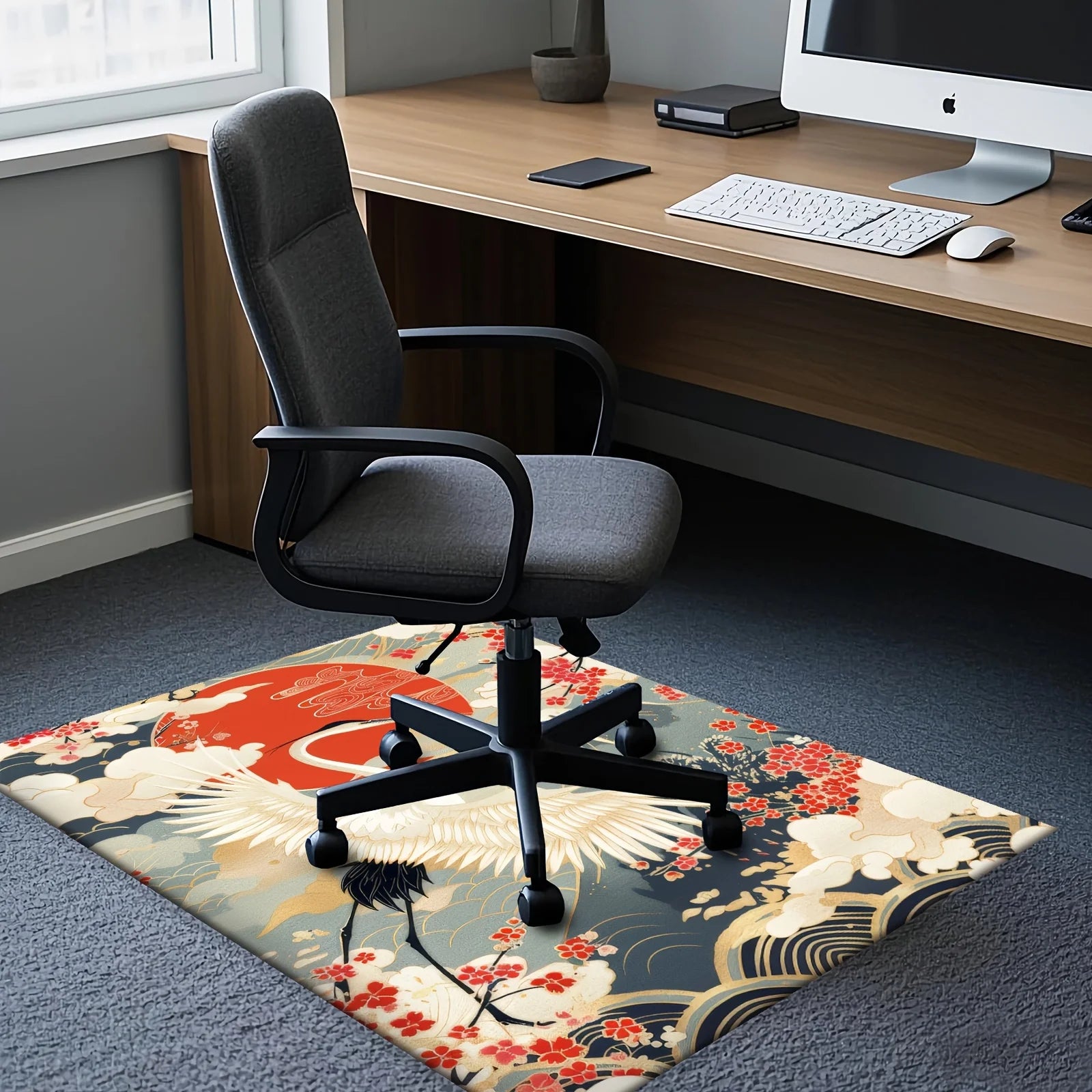 Decorative rug with a crane design in front of a computer desk with a chair.