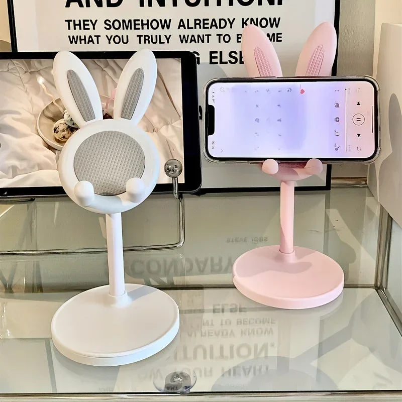 Cute rabbit-shaped adjustable phone stand with bunny ears in pink and white, shown with product packaging displaying 32cm height adjustment