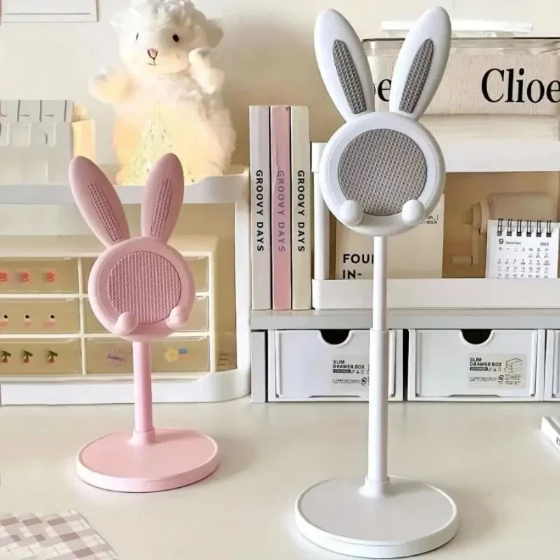 Cute rabbit-shaped adjustable phone stand with bunny ears in pink and white, shown with product packaging displaying 32cm height adjustment