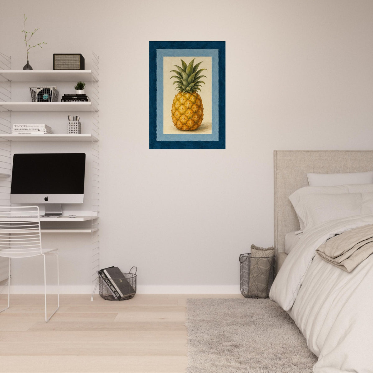 A framed wall art print featuring a pineapple illustration hanging on a bedroom wall above a bed and next to a desk setup.