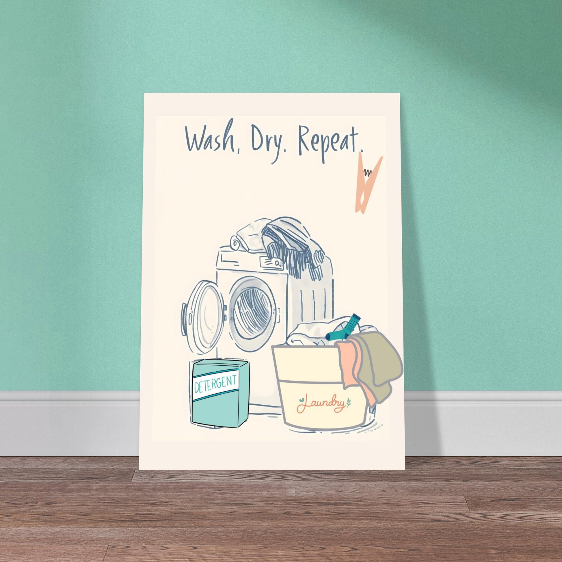 Poster with a laundry-themed illustration and text 'Wash. Dry. Repeat.' on a teal wall.