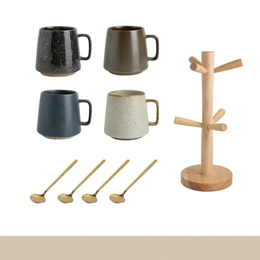 Set of ceramic mugs and wooden spoon holder on a white background