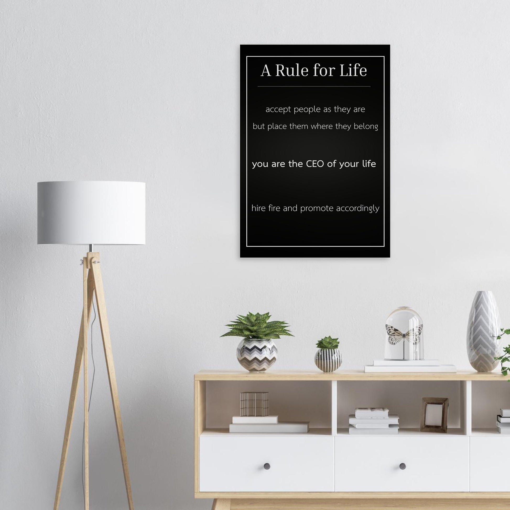 Framed poster with 'A Rule for Life' quote on a wall above a shelf with decor items.