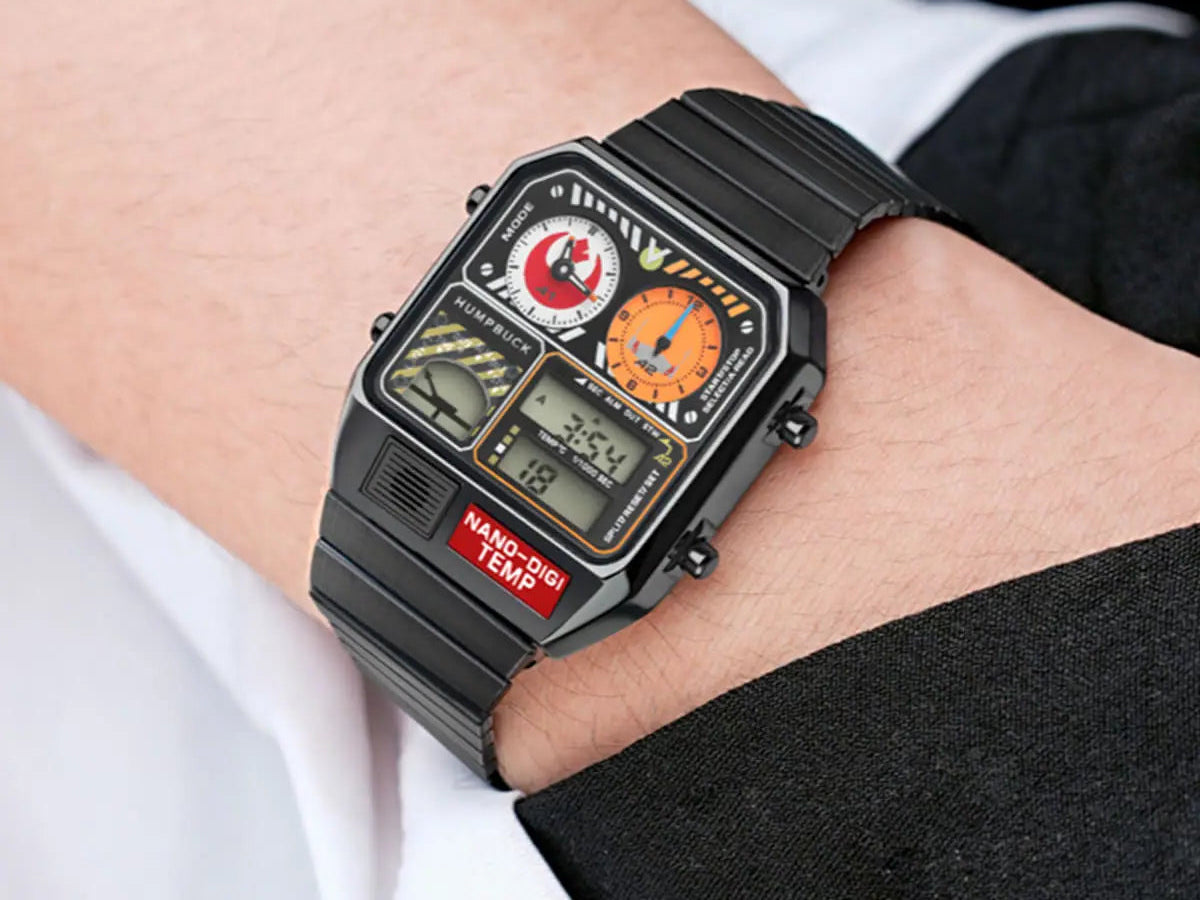 Digital watch with a black strap on a wrist, worn with a white shirt and black pants.