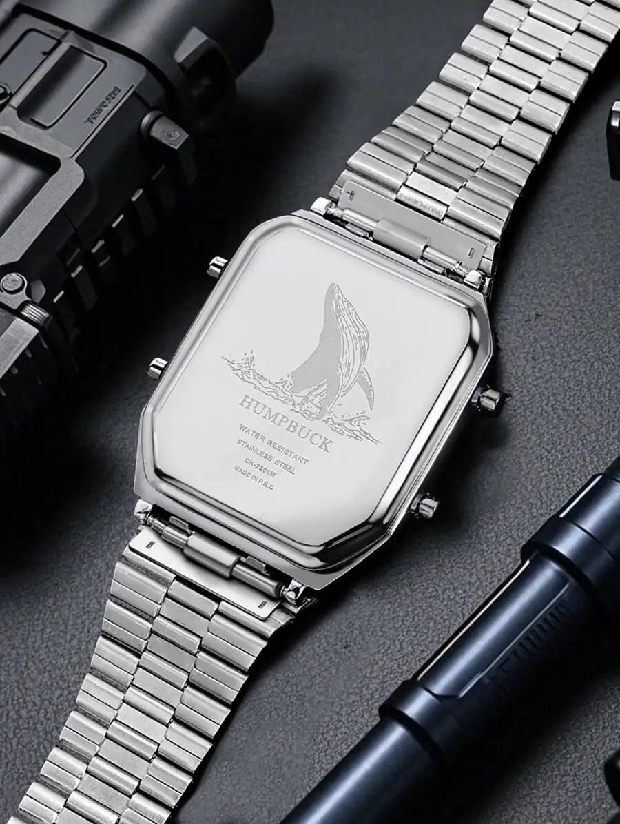 Silver watch with engraved design on a dark surface