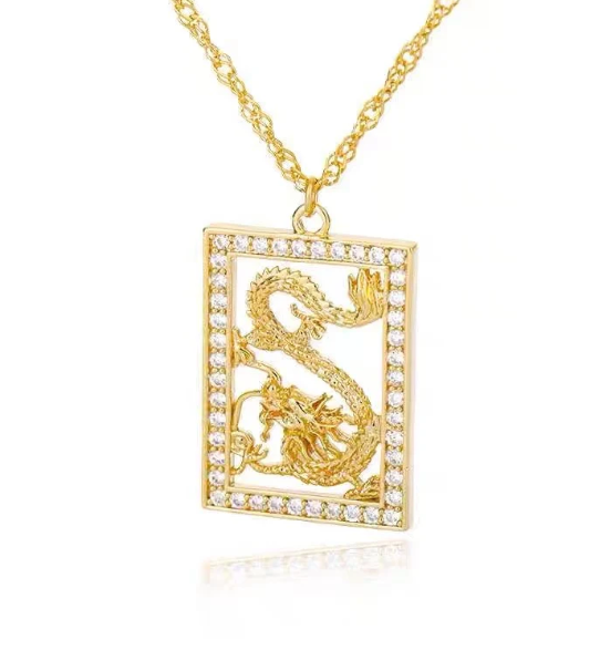 Gold dragon pendant necklace on a white background