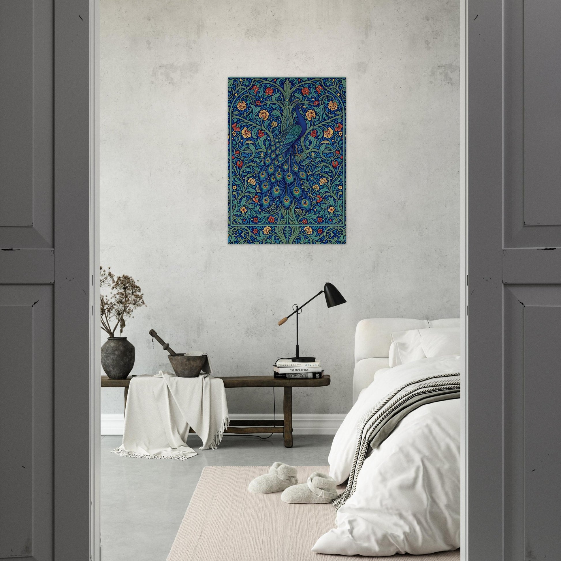 A vertical canvas art print featuring a detailed blue peacock with floral and leafy patterns, displayed on a textured light gray wall in a modern, minimalist bedroom setting.