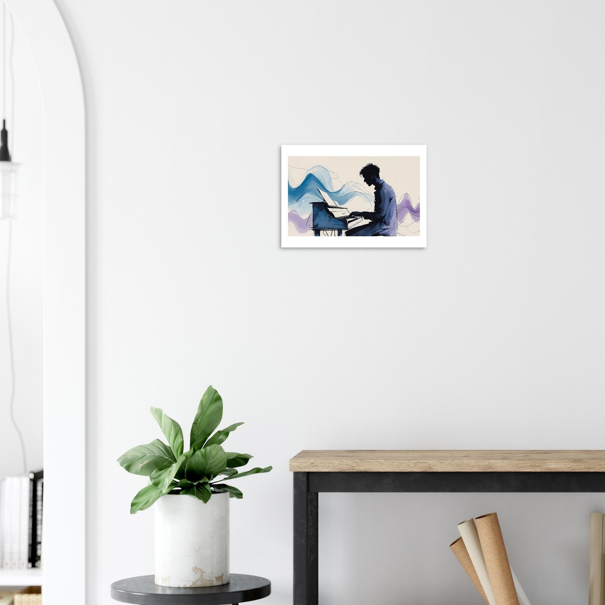 Framed artwork of a person playing a piano on a wall above a plant and desk.