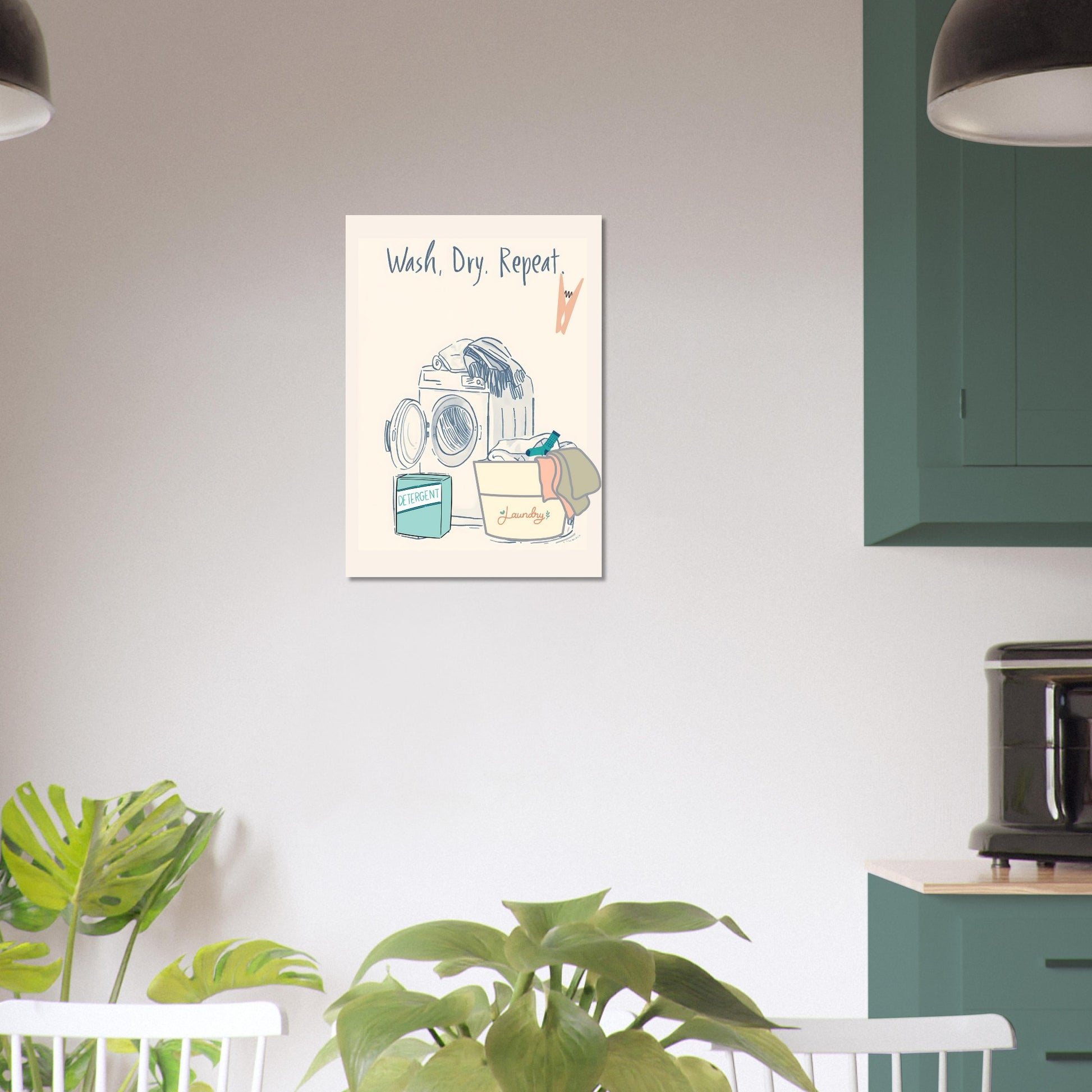 Wall art with a laundry-themed illustration on a white wall above a green cabinet.