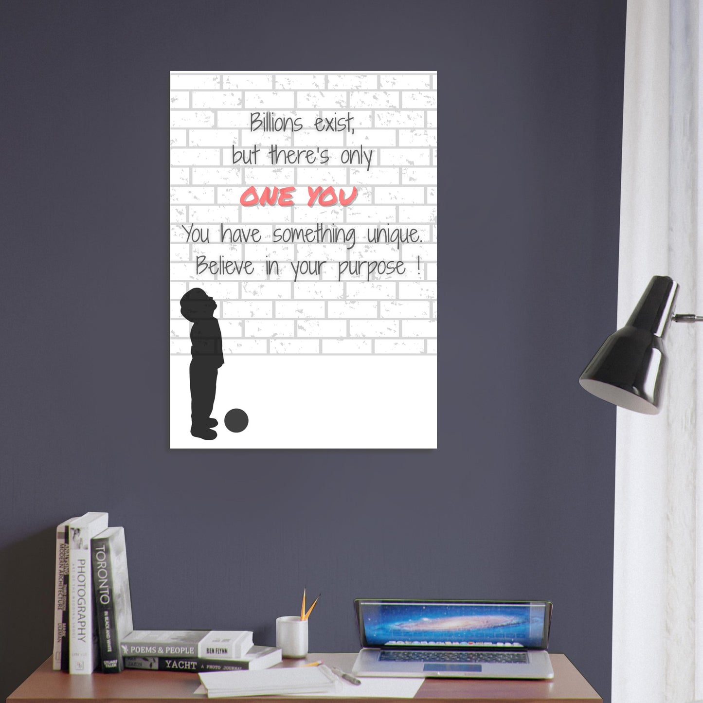 Motivational poster with silhouette of a child against a brick wall on a dark purple wall above a desk.