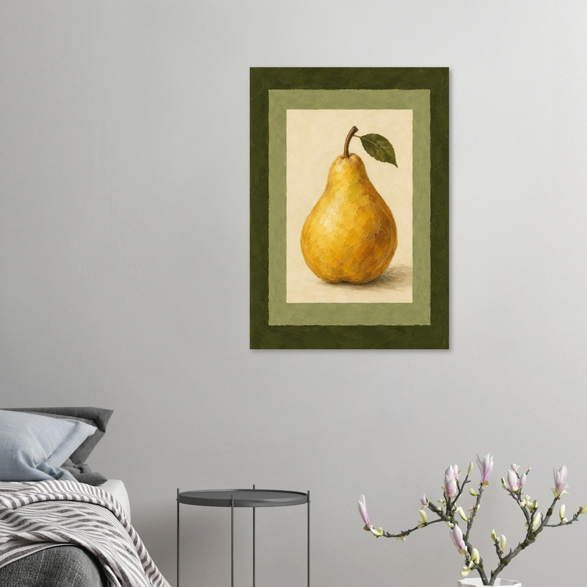 A framed wall art print featuring a yellow pear with a green leaf, displayed in a styled bedroom setting above a bed with a small side table and flowering branches in the foreground.