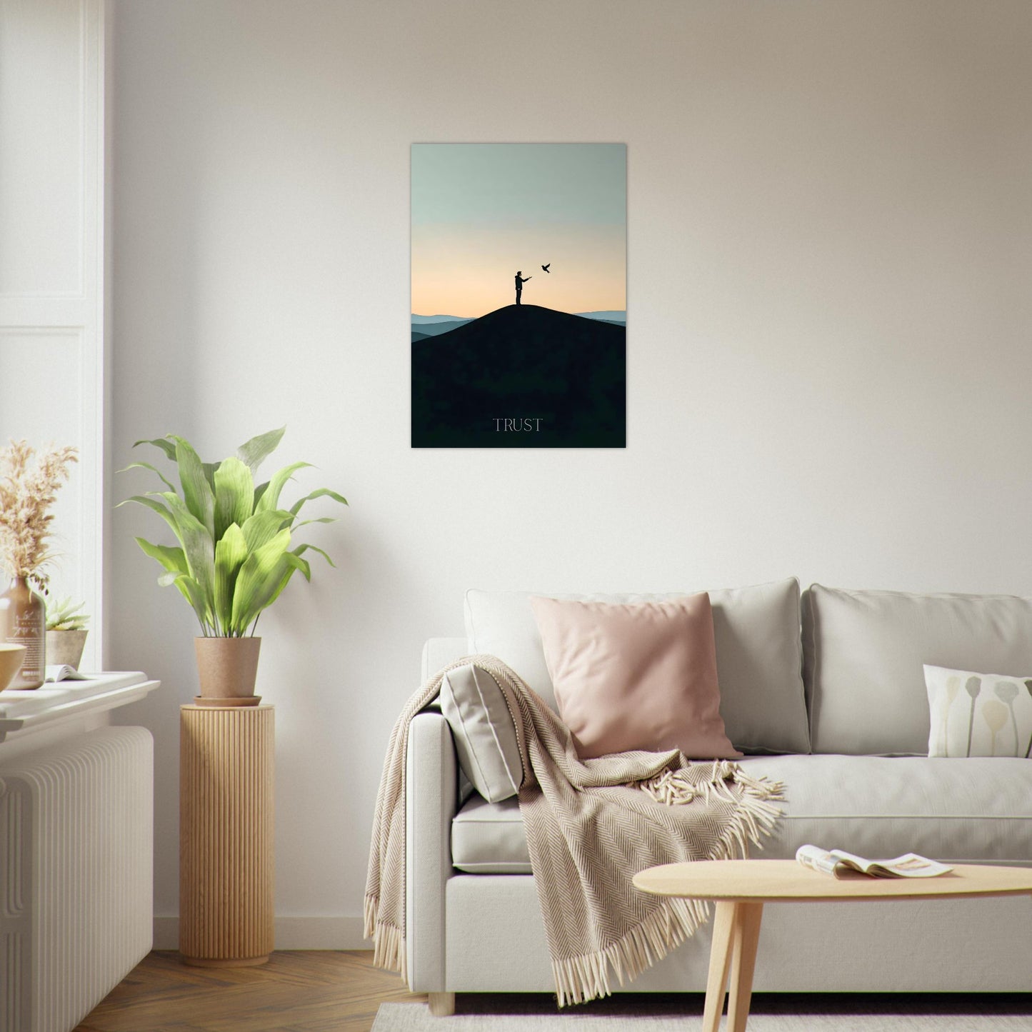 Framed trust sunset poster leaning against a wall in a bright Scandinavian living room