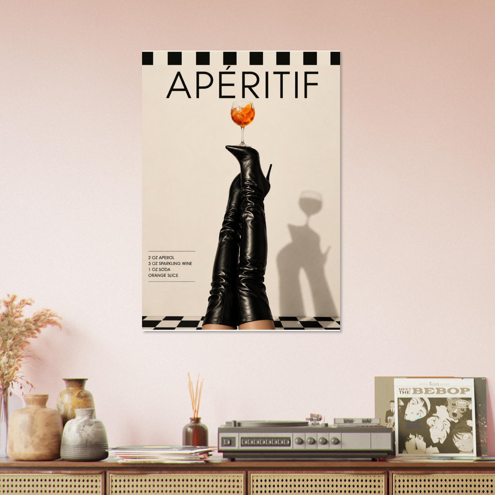 Aperitif fashion print styled above vintage console table with warm neutral decor