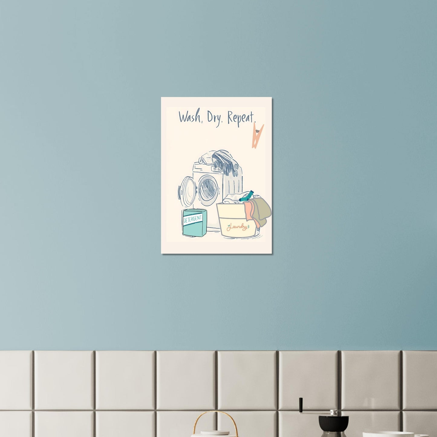 Wall art with a washing machine and laundry-themed design on a light blue wall.