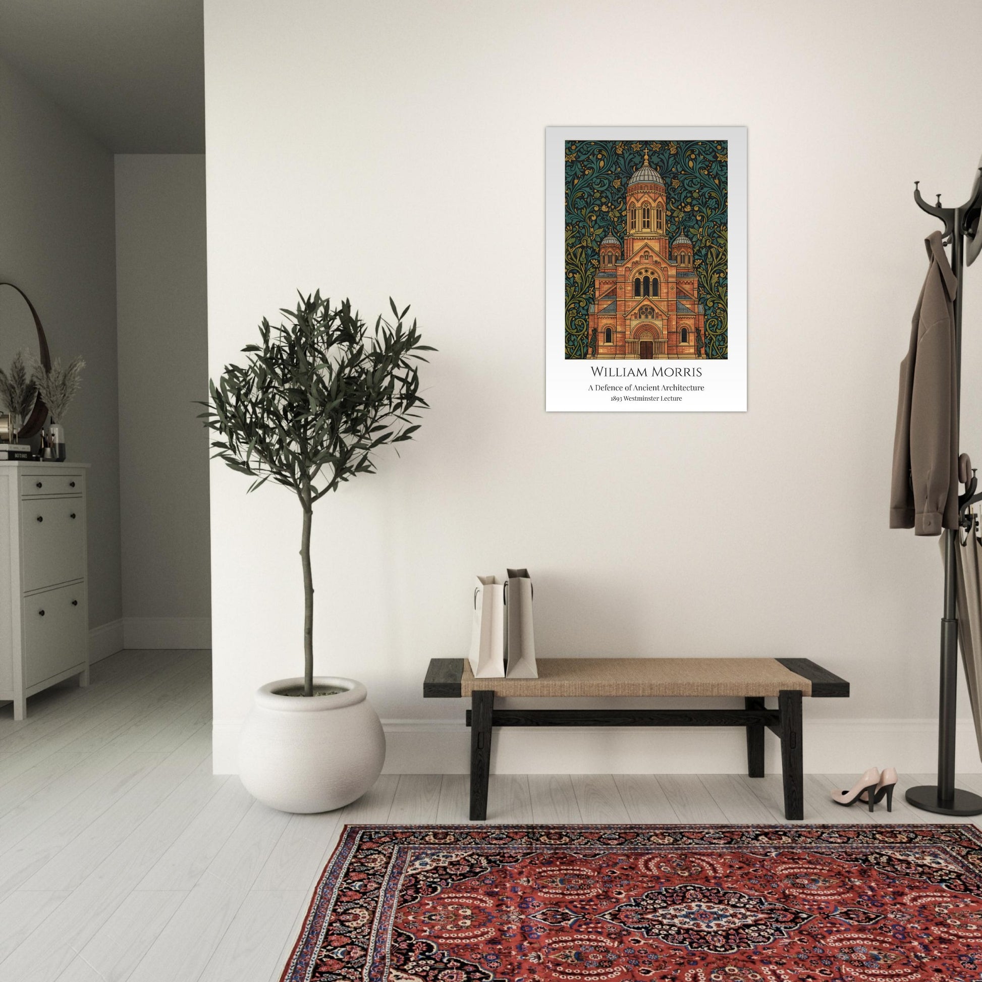 Framed William Morris artwork of a building on a wall in a room with a plant, bench, and rug.