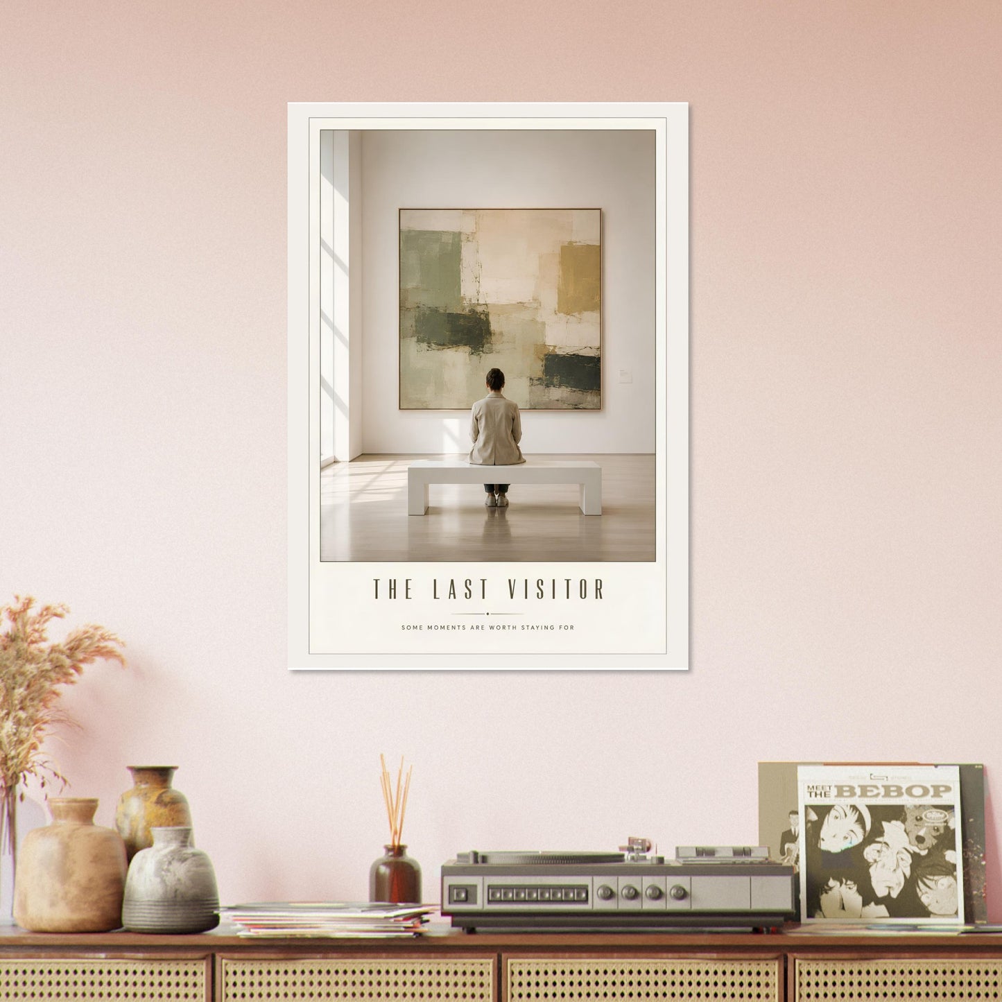 Framed artwork titled 'The Last Visitor' on a wall with decorative items below.