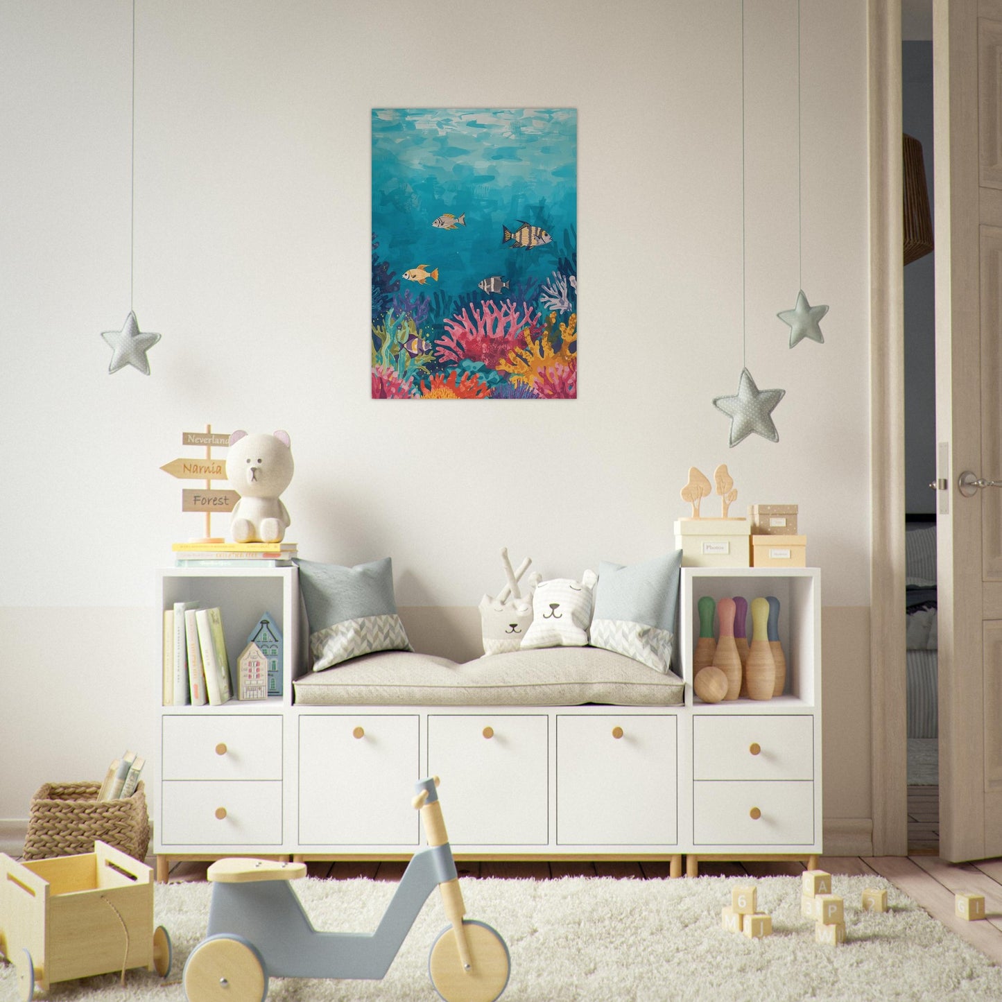 Children's room with white storage unit, toys, and an underwater-themed wall art.