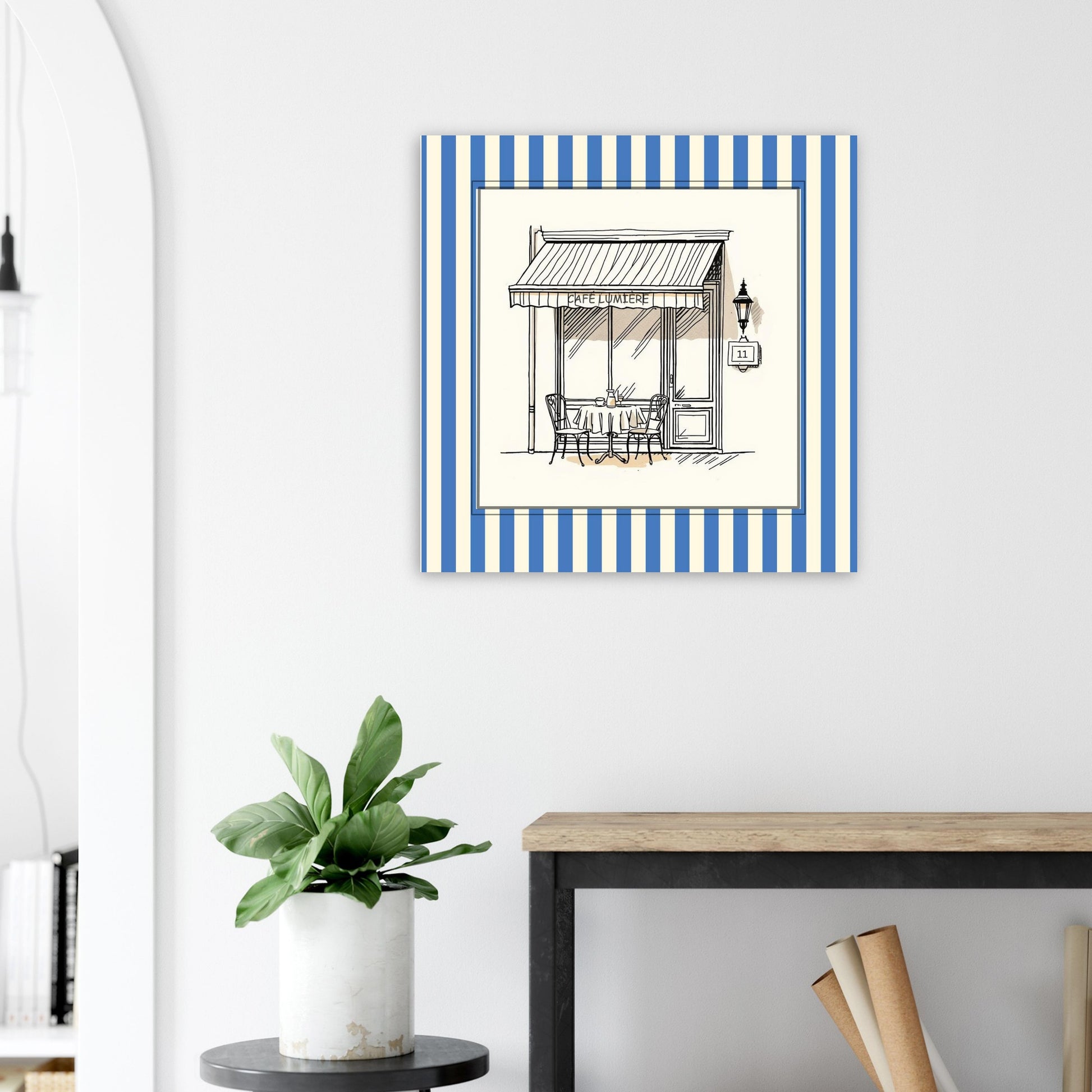 French café storefront art print in blue above sofa in bright living room
