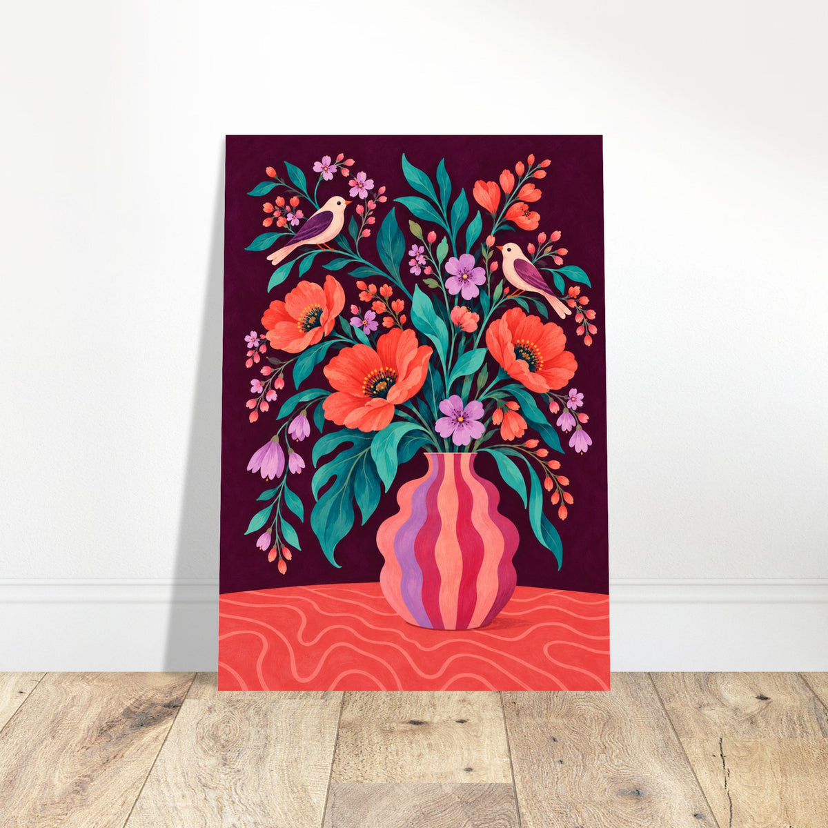 A vertical art print featuring a colorful floral bouquet in a striped vase with birds and leaves, displayed leaning against a white wall on a light wood floor.