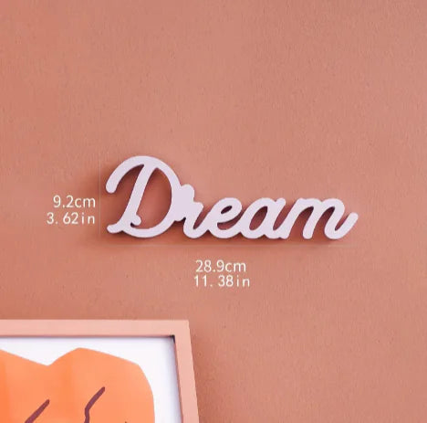 Decorative word 'Dream' on a brown background with measurements