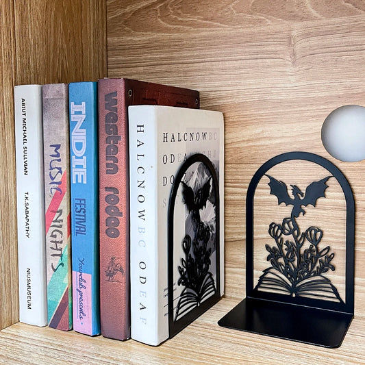 Bookends with dragon design on a wooden shelf with books
