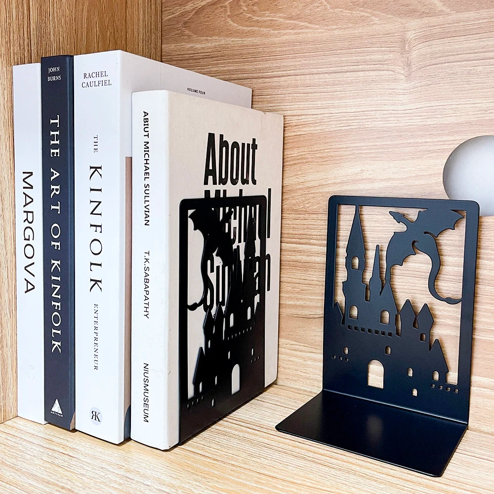 Bookends with castle design on a wooden surface with books.