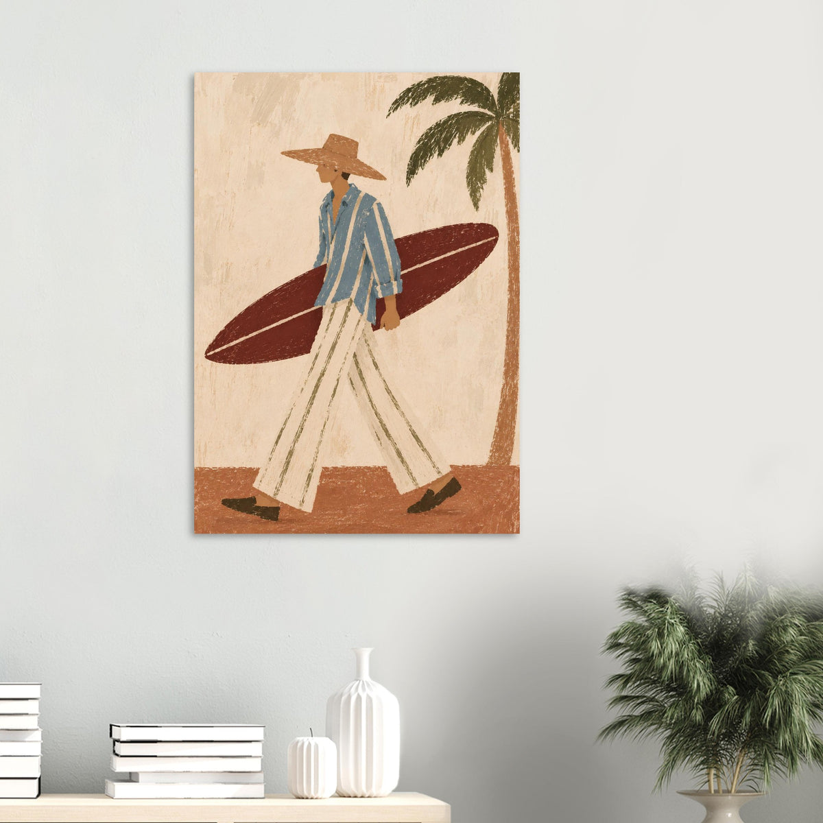 Surfer illustration on a pale green wall above a white console with stacked books and a leafy plant.