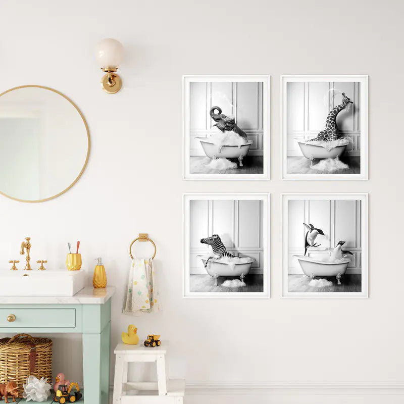 Set of four framed black and white prints of a child in a bathtub on a wall above a bathroom vanity.