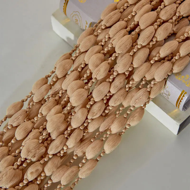 Beige beaded curtain on a white background