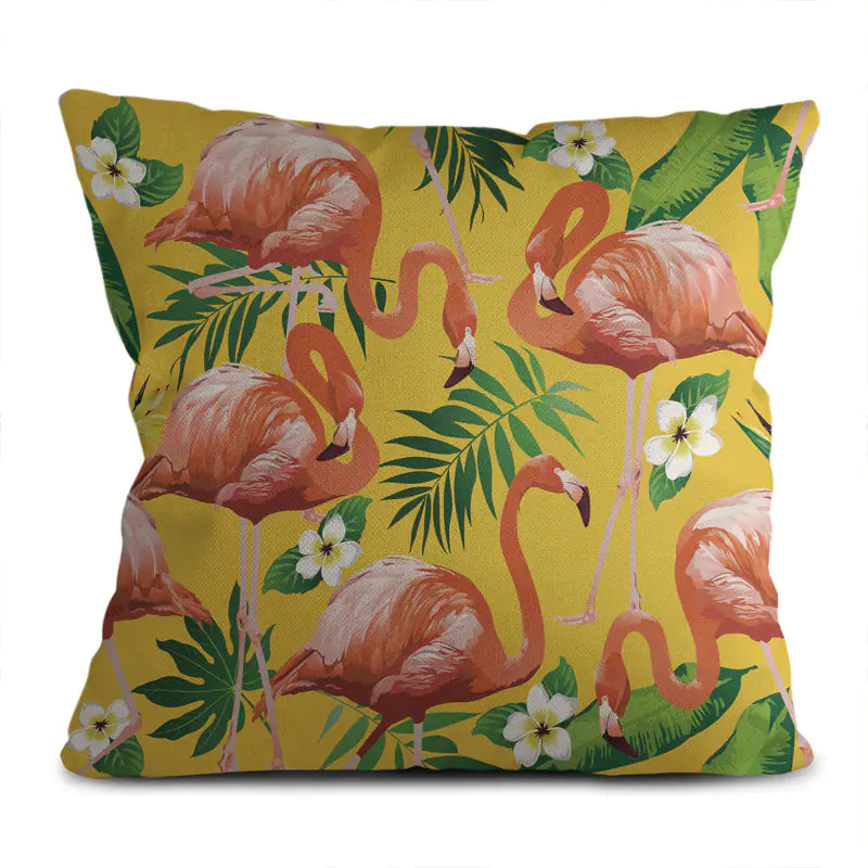 Decorative pillow with flamingo and tropical leaf pattern on a yellow background