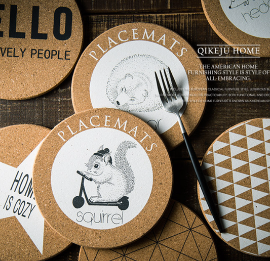 Round cork placemats with illustrations and text on a wooden surface.