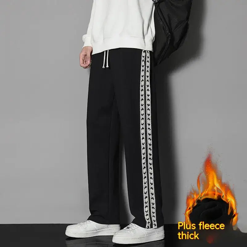 Black pants with chain design on a gray background