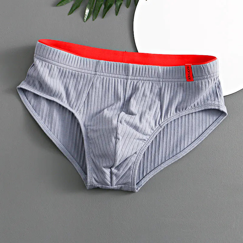 Gray underwear with red waistband on a gray background