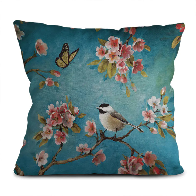 Decorative pillow with a bird and floral design on a blue background