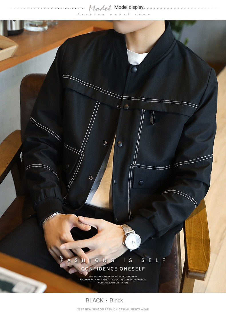 Person wearing a black jacket sitting on a chair indoors