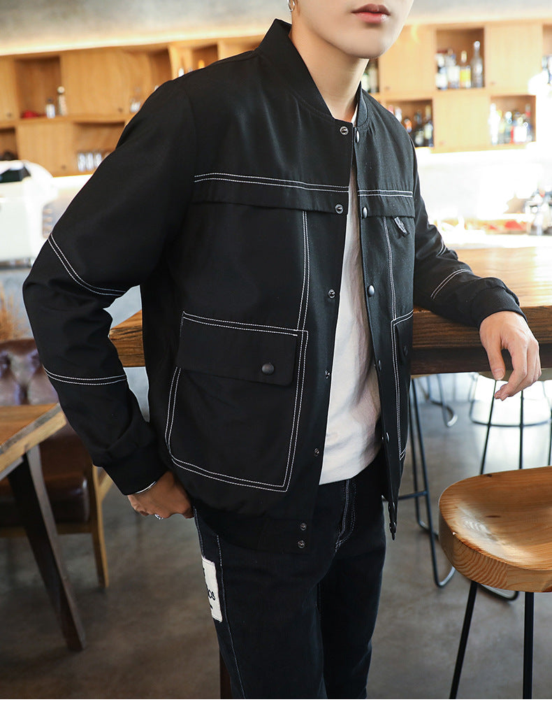 Person wearing a black jacket with white accents in an indoor setting