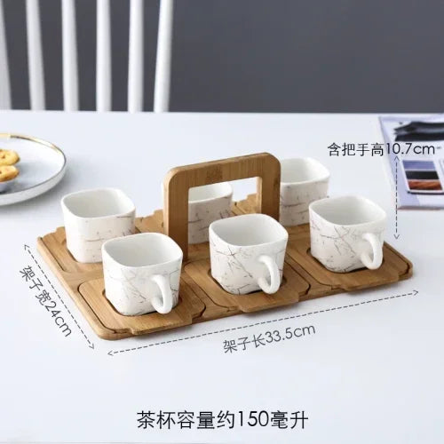 Set of ceramic cups with a wooden tray on a table