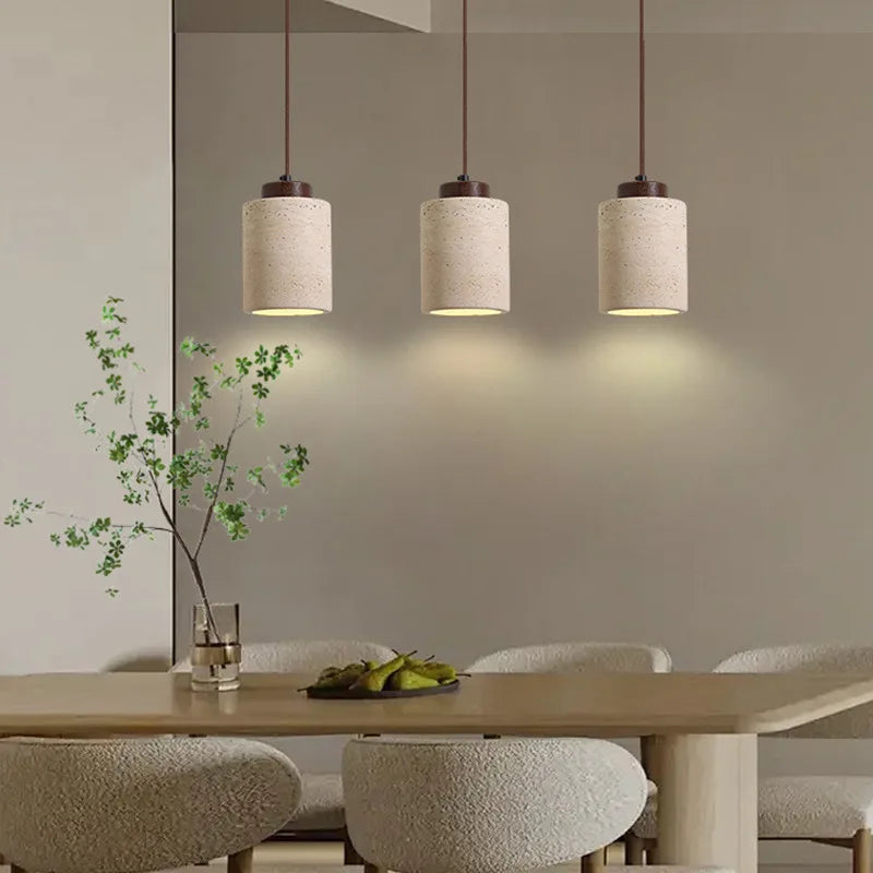 Japanese Wabi-Sabi pendant light made of natural yellow cave stone, minimalist modern in a Dining room with , table, and chairs.