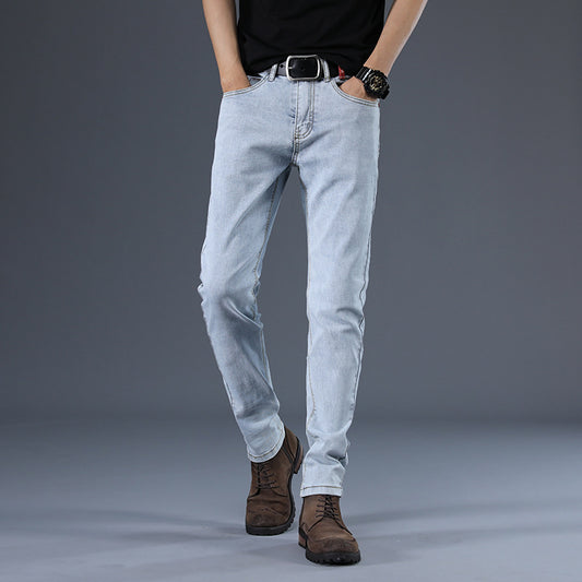 Person wearing light blue jeans and brown boots on a gray background