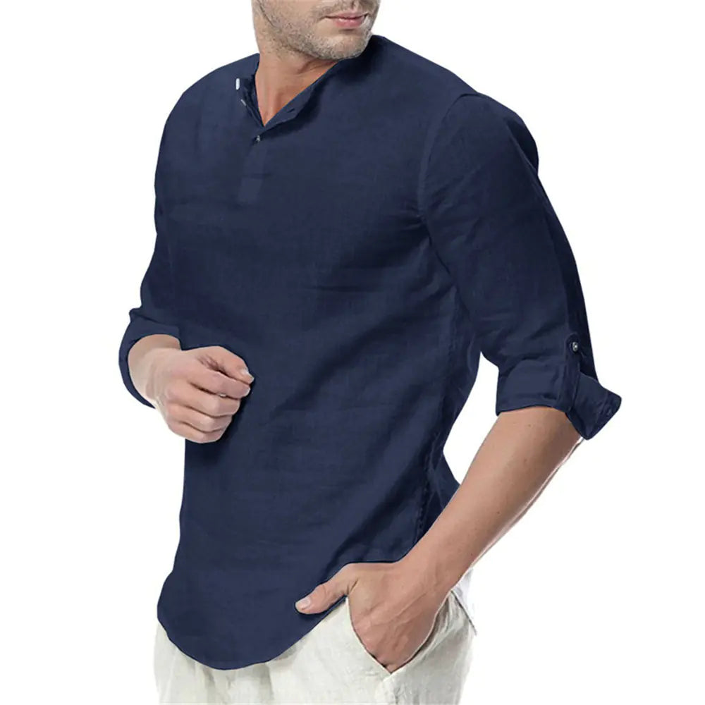 Man wearing a navy blue shirt with rolled-up sleeves on a white background