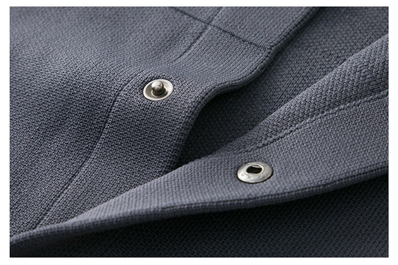 Close-up of a dark blue fabric with metal buttons