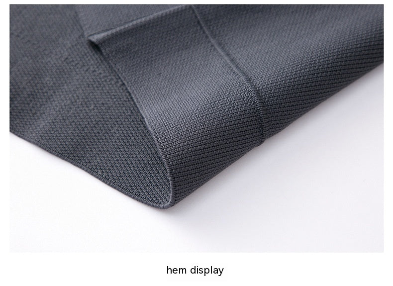 Close-up of a dark gray fabric hem on a white background